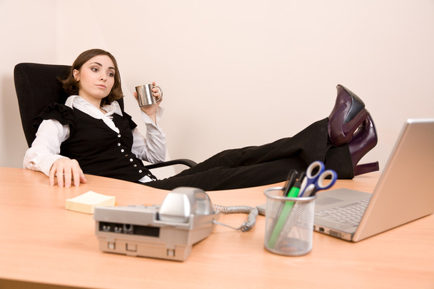 Young businesswoman relaxing at office - Fotó, kép