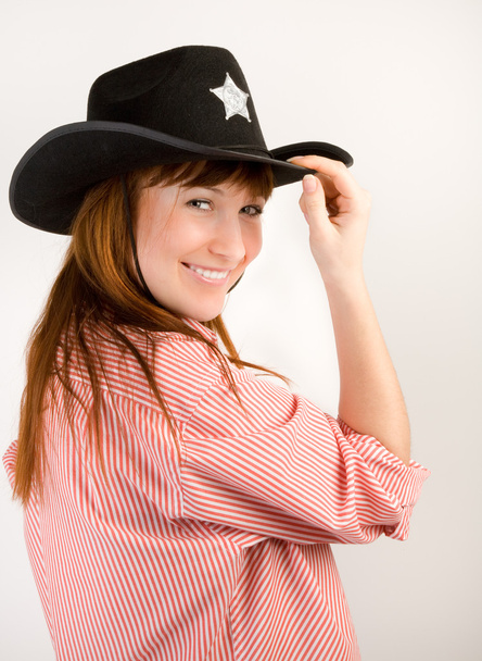 Red haired cowgirl in hat looking to the camera - Fotografie, Obrázek