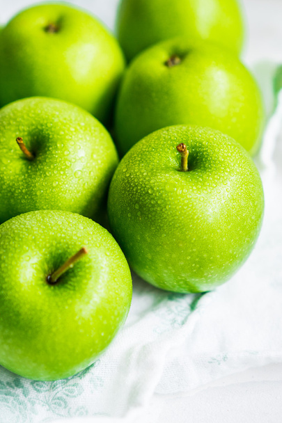 Bright green apples on white napkin - Fotó, kép