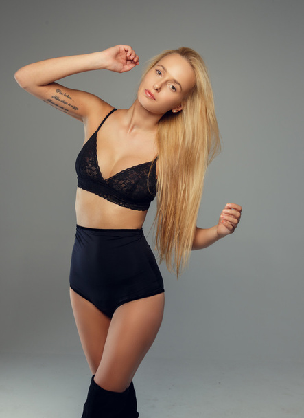 Blond woman in black underwear - Foto, afbeelding