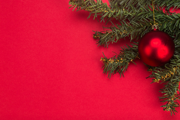 Simple red Christmas background with fir tree and ornaments. - Photo, Image