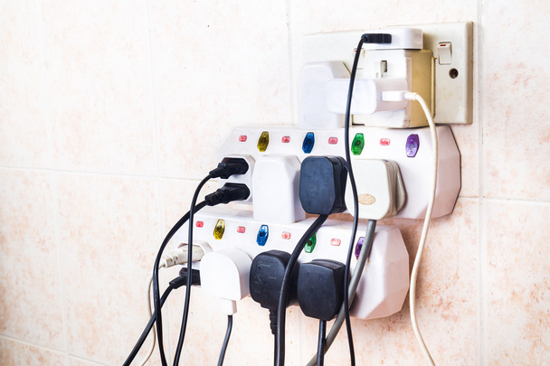 Multiple electricity plugs on adapter risk overloading and dange - Photo, Image