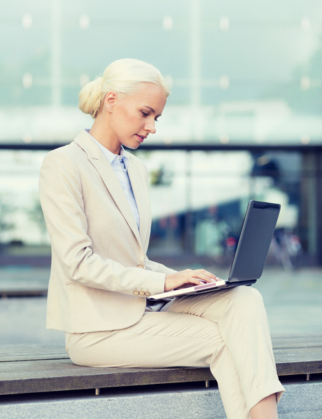 businesswoman working with laptop outdoors - 写真・画像