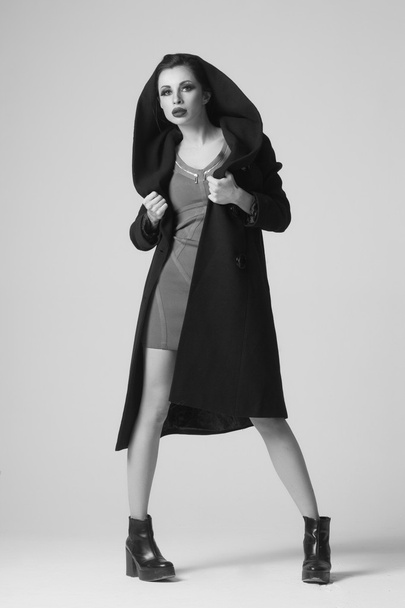 Beautiful sexy woman in a black coat for autumn winter fashion - 写真・画像