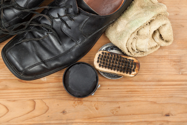 Shoe polish with brush, cloth and worn men shoes on wooden platf - Photo, Image