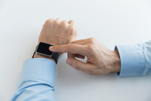 close up of male hands setting smart watch - Foto, Imagen