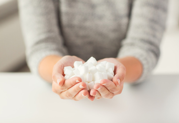 close up of white lump sugar in woman hands - Foto, immagini