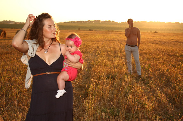 Happy family in wheat field in sunny day sunset - Photo, Image