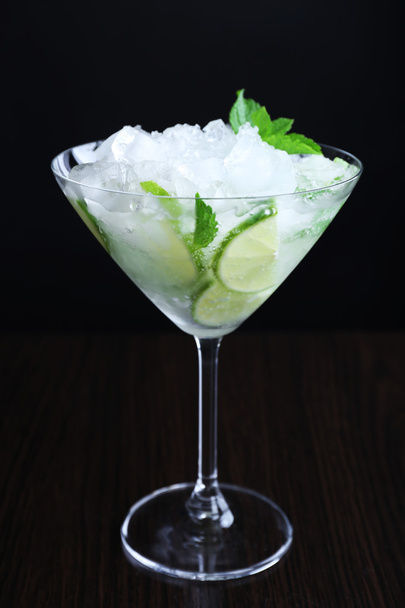 Glass of cocktail with ice on dark background - Photo, Image