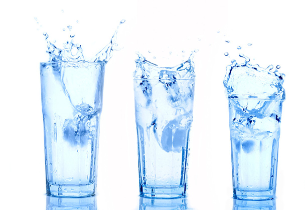 Water splash in glasses isolated on white - Foto, Imagem