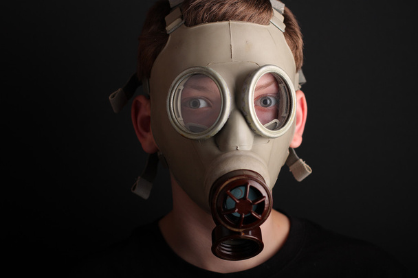 Man with gas mask on black  background - 写真・画像