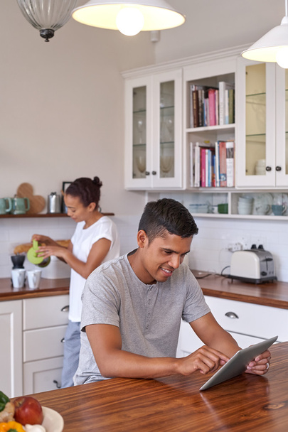 couple with coffee and tablet computer in kitchen - Valokuva, kuva