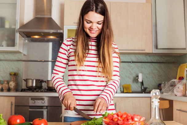 Young Woman Cooking Vegetable Salad.  Dieting Concept. - 写真・画像
