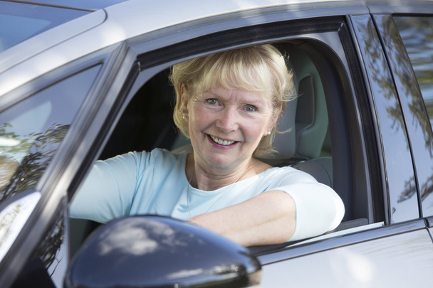 Portrait Of Smiling Senior Woman Driving Car - Foto, afbeelding