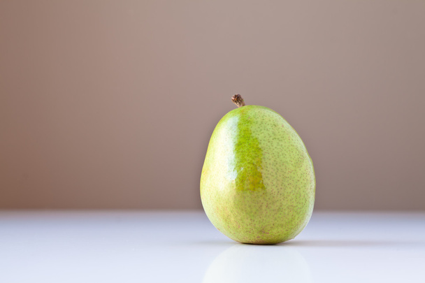 Green Pear on White with Brown Background - Zdjęcie, obraz
