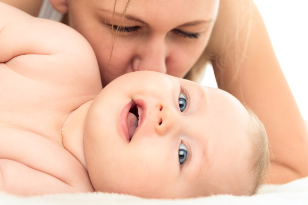 Family. Woman and newborn child. Portrait of a happy mother and baby. Woman kissing a infant - Foto, Imagem