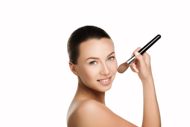 young beautiful brunette woman with nude makeup smile and hold brush at face. naturalness isolated photo. - Foto, Imagem