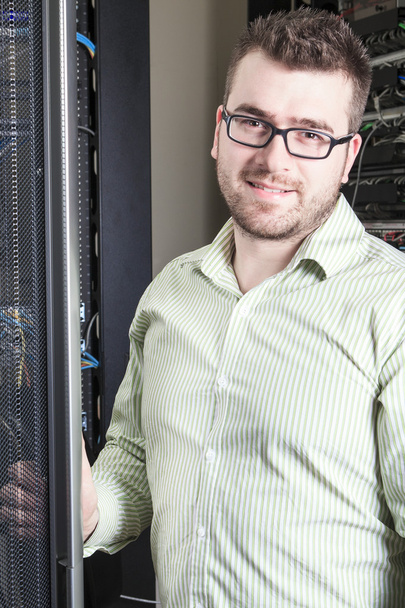 Network engineer working in server room - Photo, Image