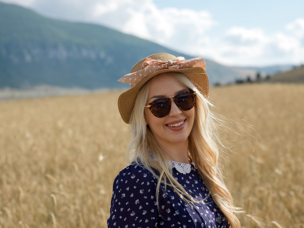 Romantic girl in a rural barley field. Summer, autumn life, freedom concept - Φωτογραφία, εικόνα