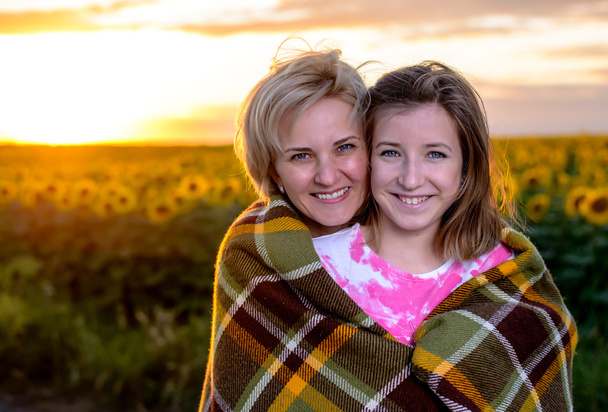 Mother and Daughter on Country Road at Sunset - 写真・画像