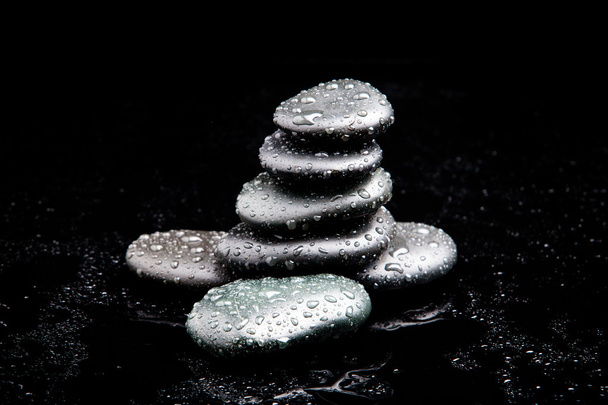 Spa Stones. black shiny zen stones with water drops over black b - Photo, Image