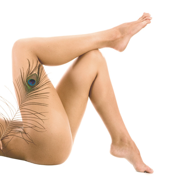 Woman Legs With Peacock Fearther over White Background - Foto, afbeelding