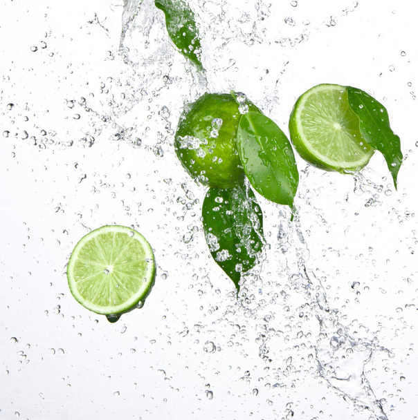 Fresh limes with water splash - Photo, image