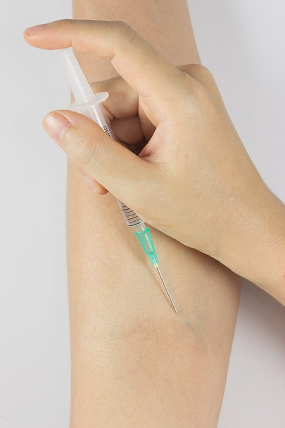 hand with syringe on white - Фото, зображення