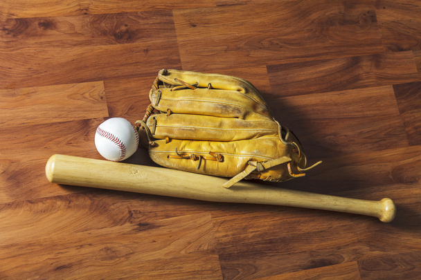 Baseball bat with ball and baseball glove on wood background - Photo, Image