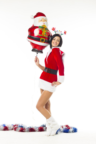 Beautiful young woman dressed as Santa Claus on a white backgrou - Zdjęcie, obraz