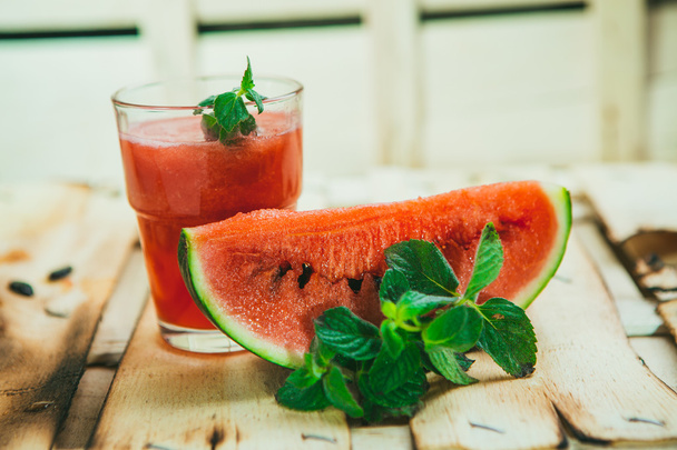 watermelon smoothie and fresh on a light wood background. selective focus to mint - Foto, afbeelding