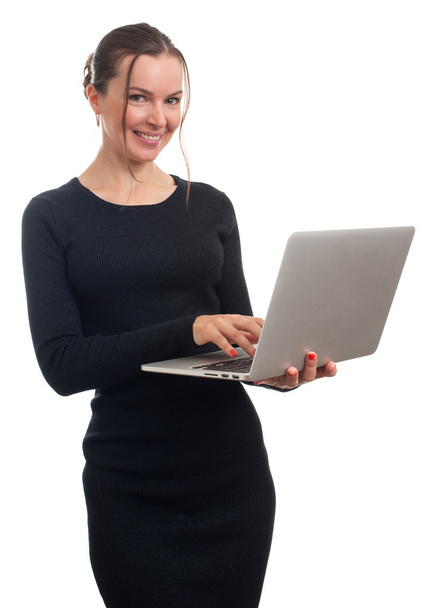 Smiling business woman holding and working on laptop - Fotó, kép