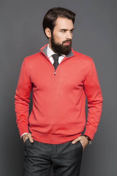 Young man with a beard and a jersey and trousers, standing - Foto, Imagem