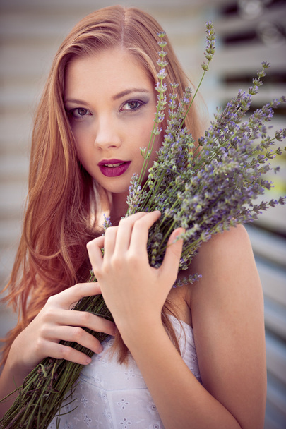Beautiful young woman on lavender field - Фото, изображение