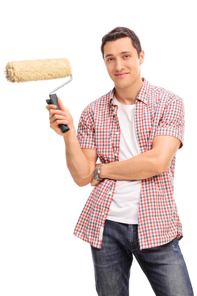 young man holding a paint roller - Foto, Imagem