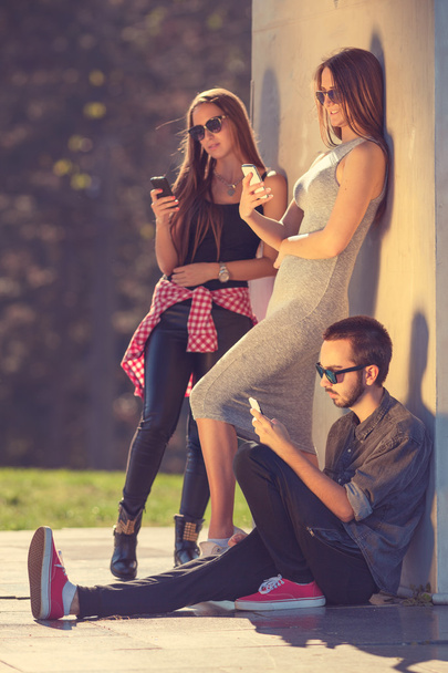 Group of young hipsters chatting by phones - Photo, Image