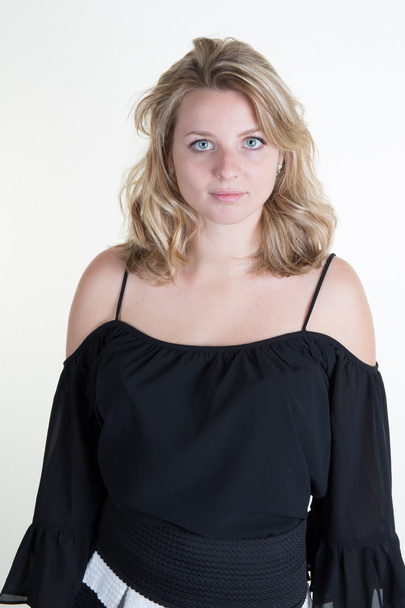 Blond young woman with a black top - Photo, Image