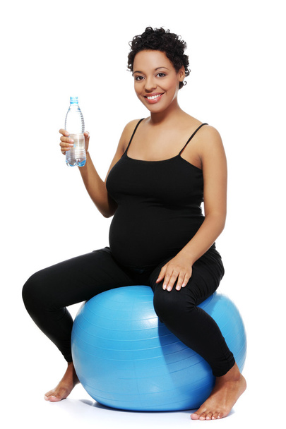 Pregnant woman during exercising. - Foto, afbeelding