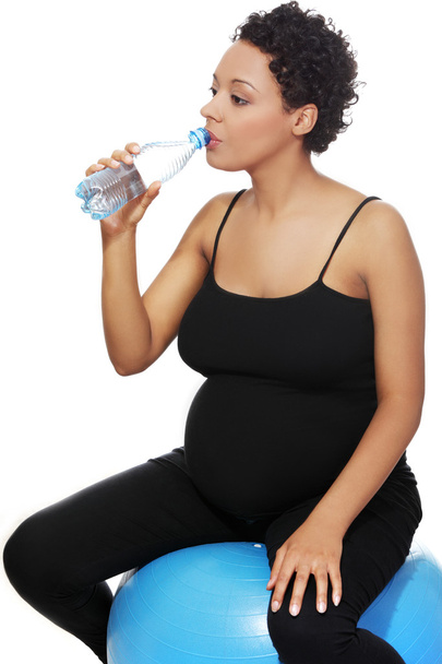 Pregnant woman during exercising. - Фото, изображение