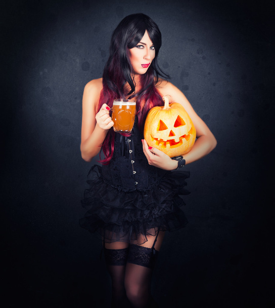 Beautiful witch in black gothic Halloween costume - Fotó, kép