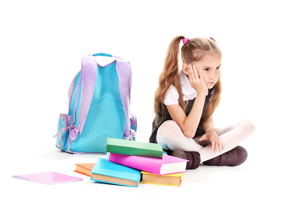 Beautiful little girl, books and a backpack isolated on white - Foto, immagini