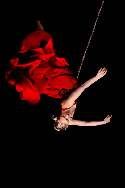 Woman gymnast in red dress - Valokuva, kuva