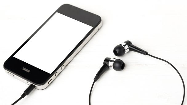 teléfono móvil con auriculares
 - Foto, Imagen