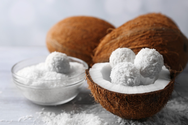 Candies in coconut flakes and fresh coconut - Foto, imagen