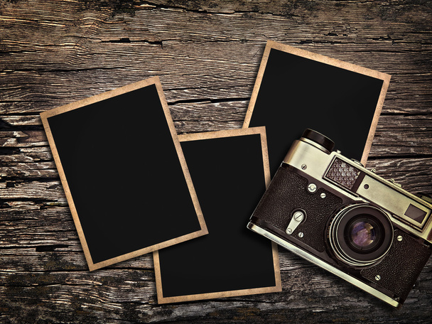 old vintage camera and photos on a wooden background - Photo, Image