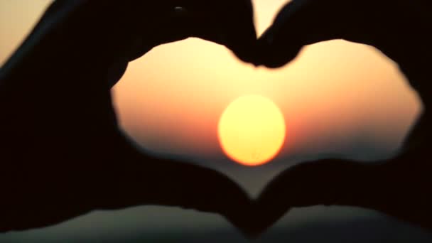Sun in heart shaped hands. - Footage, Video