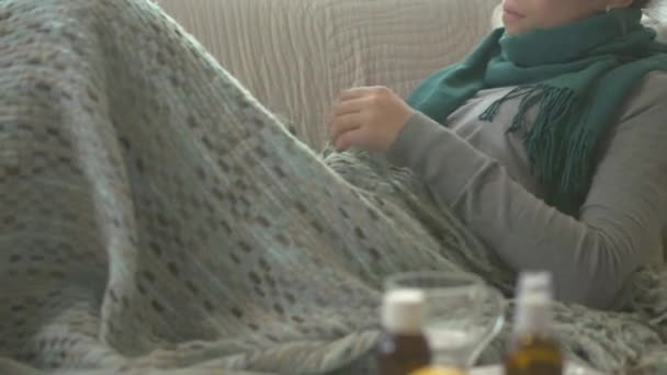 Sick woman lying on her sofa - Footage, Video