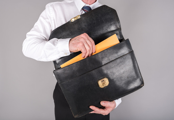 Businessman taking a folder out of his briefcase - Photo, Image