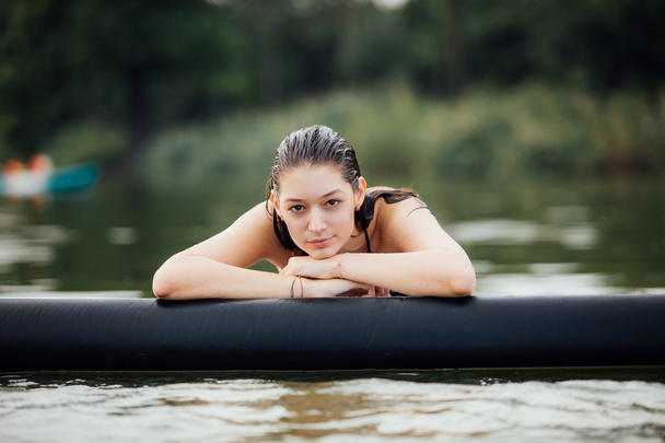 wet woman in water on paddleboard - 写真・画像