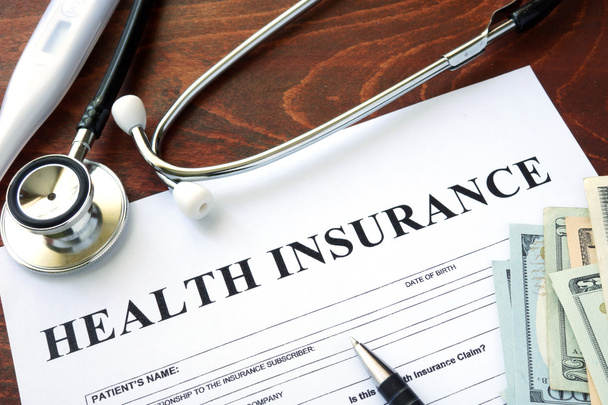 Health insurance  form and dollars on the table. - Foto, Imagem